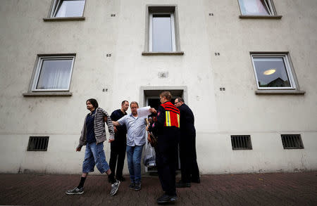 Firefighters and police officers observe the evacuation of Sister Sigrid's nursery home for homeless people as 60,000 people in Germany's financial capital are about to evacuate the city while experts defuse an unexploded British World War Two bomb found during renovations on the university's campus in Frankfurt, Germany, September 3, 2017. REUTERS/Kai Pfaffenbach