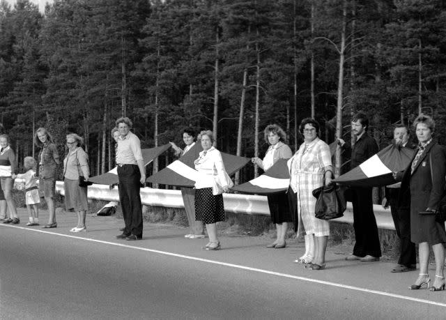 People hold hands and Latvian flags as they participate in a human chain at Baltic Way near Riga August 23, 1989. Runners left Lithuania and Estonia on August 22, 2009, for neighbouring Latvia to start events marking the 20th anniversary of a 600 km (375 mile) human chain that showed the Balts' wish to regain their independence from the Soviet Union. More than two million people in the Baltic countries of Estonia, Latvia and Lithuania joined hands in one of the biggest mass protests seen against the former Soviet Union and demanded the restoration of independence. Picture taken August 23, 1989. 