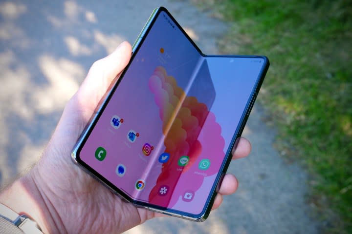 A person holding a partially open Galaxy Z Fold 4.