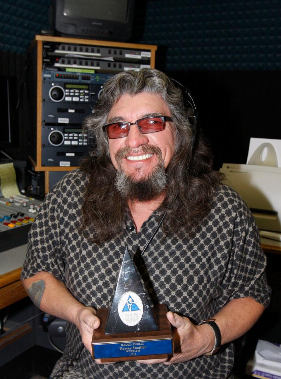 Harvey Stauffer poses Sunday, March 11, 2012, with his "Keeping the Blues Alive" award inside the studio of WVPE-FM (88.1) in Elkhart. He won the award that year from The Blues Foundation in Memphis for his contribution to blues music as the host of his "Blues Revue" program on WVPE. The program started in 1983.