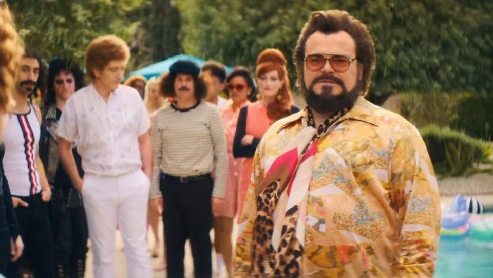 Jack Black as Wolfman Jack at a pool party as other celebs look on in Weird