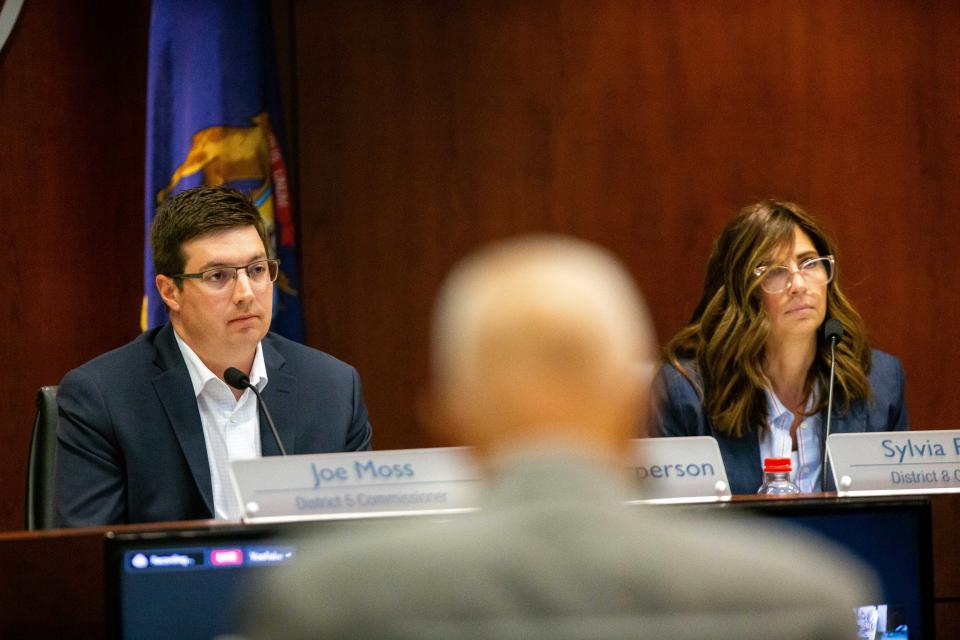 Joe Moss and Sylvia Rhodea listen to public comment during the board's meeting Tuesday, June 27, 2023, at the Ottawa County Offices in West Olive.