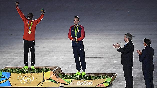 Gold medalist Eliud Kipchoge of Kenya and bronze medalist Galen Rupp of the United States stand on the podium at the medal ceremony for the Men's Marathon. Pic: Getty