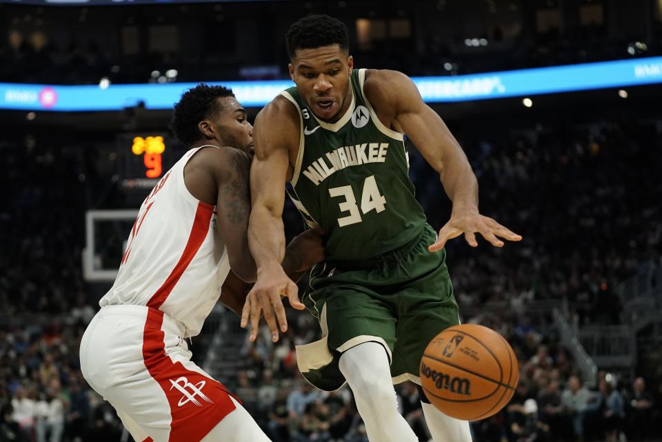 Milwaukee Bucks' Giannis Antetokounmpo goes for a loose ball in front of Houston Rockets' Tari Eason during the second half of an NBA basketball game Saturday, Oct. 22, 2022, in Milwaukee. (AP Photo/Morry Gash)