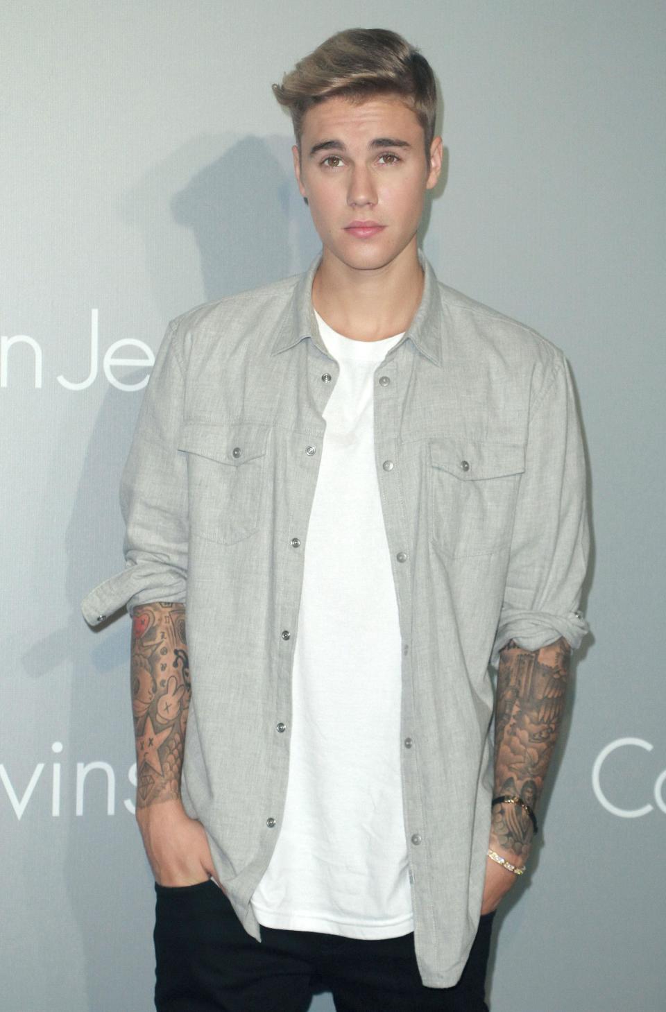 Who remembers THAT Calvin Klein shoot? This is Justin promoting the label at an event in Hong Kong, but there's something missing...