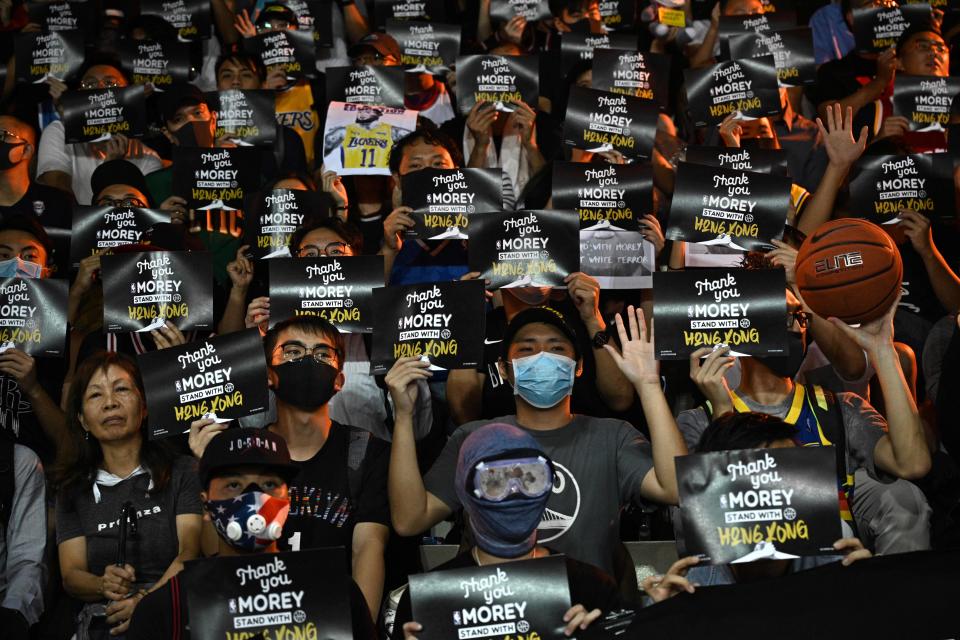 Protesters shout slogans as they hold flyers at the Southorn Playground in Hong Kong on October 15, 2019, during a rally in support of NBA basketball Rockets general manager Daryl Morey and against comments made by Lakers superstar LeBron James. - US basketball superstar LeBron James on October 14, 2019, has sharply criticised a Houston Rockets executive for angering China with a tweet supporting protesters in Hong Kong, saying the executive was "misinformed" and should have kept his mouth shut. (Photo by Anthony WALLACE / AFP) (Photo by ANTHONY WALLACE/AFP via Getty Images)