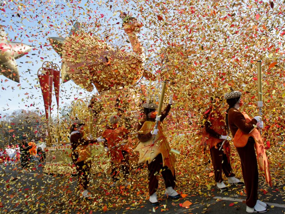 Confetti covers marchers in the parade.