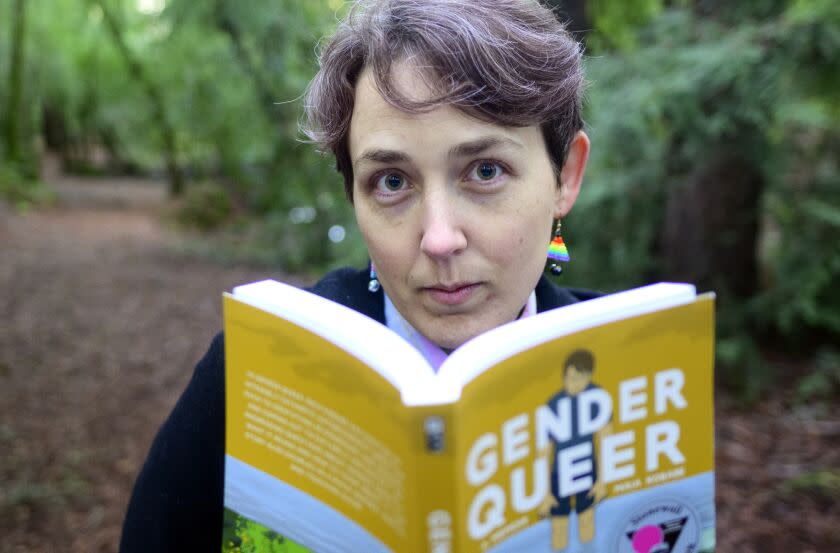 SANTA ROSA, CA - DECEMBER 13, 2022 - Maia Kobabe stands for a photo with her book "Gender Queer: A Memoir" at North Sonoma Regional Park in Santa Rosa, California on December 13, 2022. Kobabe's graphic novel about coming out as nonbinary is the most banned book in America. (Josh Edelson/for the Times)