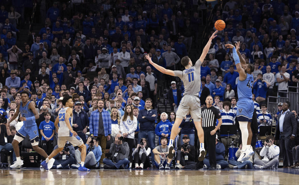 Villanova's Eric Dixon (43) shoots a 3-pointer against Creighton's Ryan Kalkbrenner (11) to give Villanova the lead in overtime of an NCAA college basketball game Wednesday, Dec. 20, 2023, in Omaha, Neb. (AP Photo/Rebecca S. Gratz)