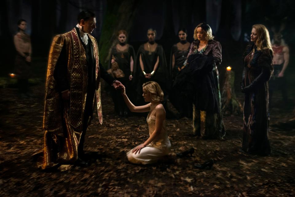 Sabrina Spellman (Kiernan Shipka, center) takes part in a dark baptism in Netflix's "Chilling Adventures of Sabrina."