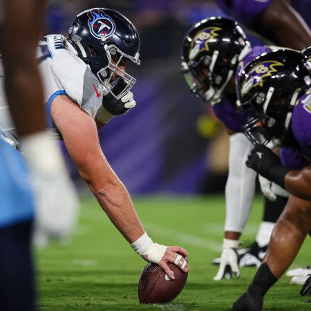 Corey Levin of the Titans prepares to snap the ball against the Ravens.