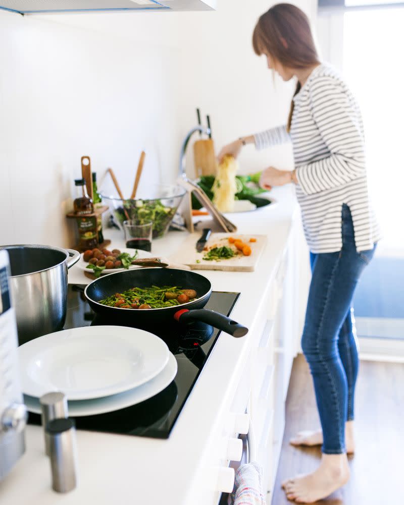 A woman cooking in a kitchen