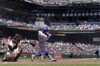 Los Angeles Dodgers' Mookie Betts (50) hits a three-run home run in front of San Francisco Giants catcher Austin Wynns during the fourth inning of a baseball game in San Francisco, Thursday, Aug. 4, 2022. (AP Photo/Jeff Chiu)