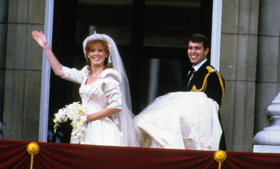 Sarah Ferguson, Duchess of York and Prince Andrew, Duke of York  stand on the balcony of Buckingham Palace and wave at their wedding on July 23, 1986 in London, England.