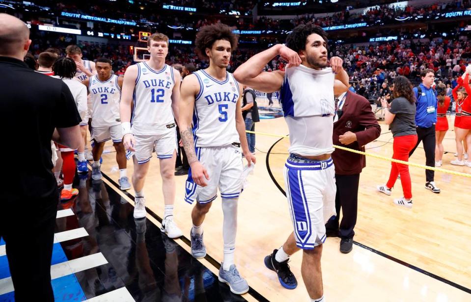 Duke players including from left Kyle Filipowski (30), Jaylen Blakes (2), TJ Power (12), Tyrese Proctor (5) and Jared McCain (0) walk off the court after shaking hands with Wolfpack players after N.C. State’s 76-64 victory in their NCAA Tournament Elite Eight matchup at the American Airlines Center in Dallas, Texas, Sunday, March 31, 2024.