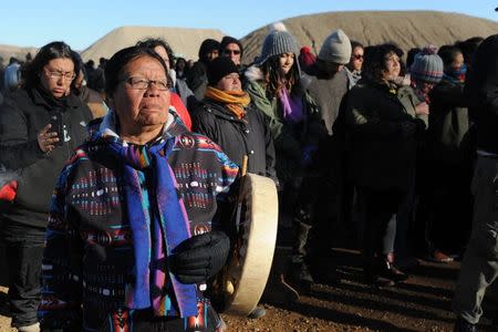 A woman beats a drum during a protest march against the Dakota Access pipeline near the Standing Rock Indian Reservation in Mandan, North Dakota, U.S. November 12, 2016. REUTERS/Stephanie Keith