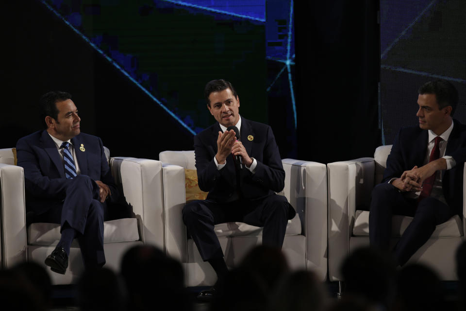 Mexico's President Enrique Pena Nieto, center, talk during an economic forum as part the XXVI Iberoamerican Summit in Antigua, Guatemala, Thursday, Nov. 15, 2018. The event is a biennial two-day meeting of heads of state from Latin America and the Iberian Peninsula. At left, Guatemala's President Jimmy Morales and right Spain's Prime Minister Pedro Sanchez (AP Photo/Moises Castillo)