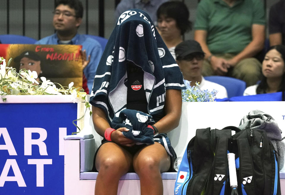 Naomi Osaka, of Japan takes a break covering her face with a towel during the final match against Karolina Pliskova, of Czech Republic at the Pan Pacific Open women's tennis tournament in Tokyo Sunday, Sept. 23, 2018. (AP Photo/Eugene Hoshiko)