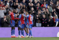 Crystal Palace's Jean-Philippe Mateta, left, celebrates scoring their fifth goal of the game during the English Premier League soccer match between West Ham United and Crystal Palace at Selhurst Park in London, Sunday April 21, 2024. (Steven Paston/PA via AP)