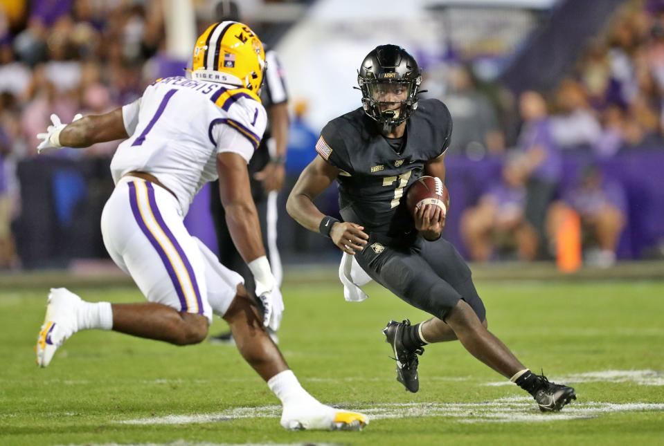 Army quarterback Champ Harris (7) runs in front of LSU linebacker Omar Speights (1) during the first half at Tiger Stadium. Danny Wild, USA TODAY Sports