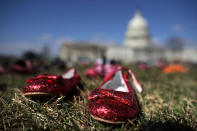 <p>7,000 pairs of shoes, representing the children killed by gun violence since the mass shooting at Sandy Hook Elementary School in 2012, are spread out on the lawn on the east side of the U.S. Capitol March 13, 2018 in Washington. (Photo: Chip Somodevilla/Getty Images) </p>