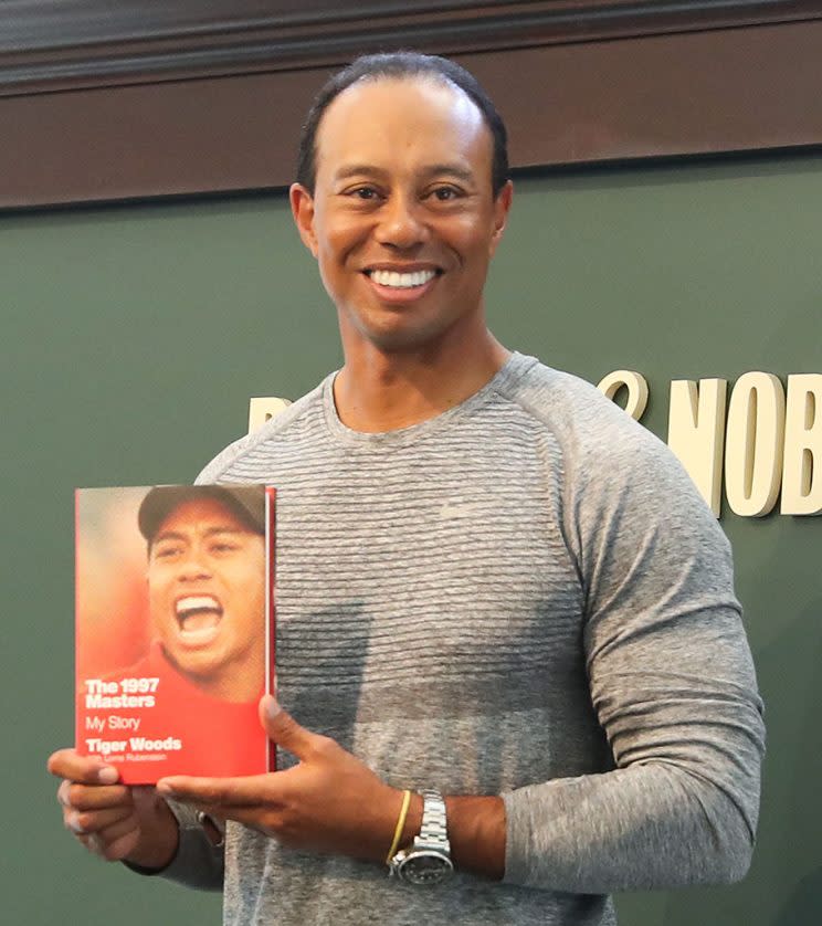 Tiger Woods signs copies of his new book, 