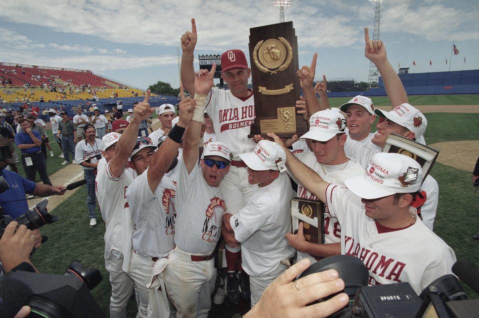 OU baseball players lift up their coach, Larry Cochell, after winning the College World Series in Omaha, Nebraska, on June 11, 1994.