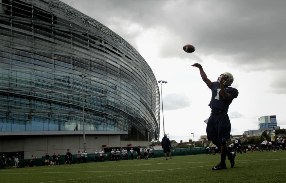 FILE - Navy quarterback Trey Miller during a training session at the Aviva Stadium, Dublin, Ireland, Aug. 30, 2012. College football is going international again with Nebraska facing Northwestern in Dublin on Saturday Aug. 27, 2022. It's the first regular-season international game in five years. (AP Photo/Peter Morrison, File)