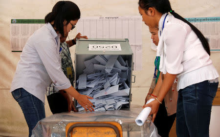Officials begin the process of counting ballots after polls have closed in Cambodia's general election, at a polling station in Phnom Penh, Cambodia, July 29, 2018. REUTERS/Darren Whiteside