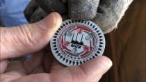 In this Aug. 21, 2019, image, a Navajo Generating Station employee holds a challenge coin that was given to workers at the plant near Page, Ariz.. The coal-fired plant will close before the year ends, upending the lives of hundreds of mostly Native American workers who mined coal, loaded it and played a part in producing electricity that powered the American Southwest. (AP Photo/Susan Montoya Bryan)