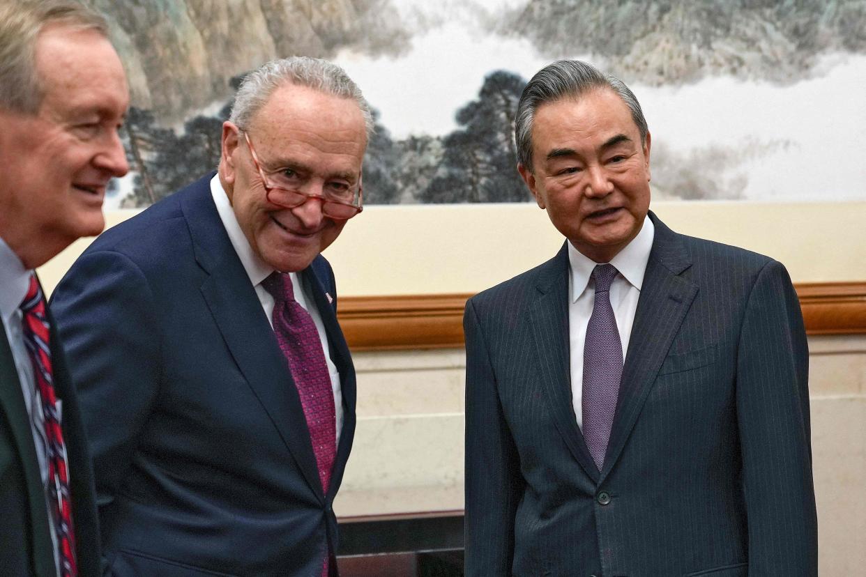 US Senate Majority Leader Chuck Schumer (centre) meets with Chinese Foreign Minister Wang Yi (right) at the Diaoyutai Guest House in Beijing on Monday (POOL/AFP via Getty Images)