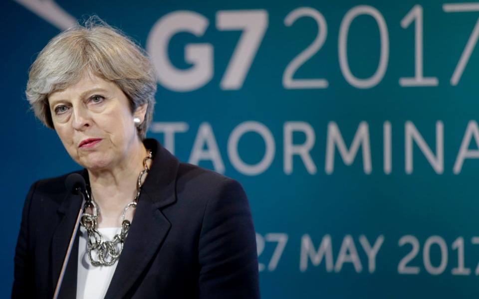 Theresa May's decisions to intervene more in the UK economy may undermine her claims to be more open to global trade and to free trade deals, analysts fear - AP