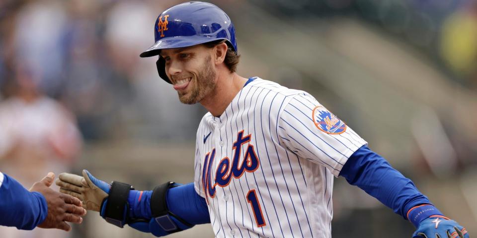 Jeff McNeil smiles and gives a high-five during a game in 2022.