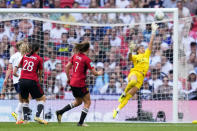 Manchester United's Ella Toone, center, scores the opening goal past Tottenham Hotspur goalkeeper Becky Spencer during the Women's FA Cup final soccer match between Manchester United and Tottenham Hotspur at Wembley Stadium in London, Sunday, May 12, 2024. (AP Photo/Kirsty Wigglesworth)