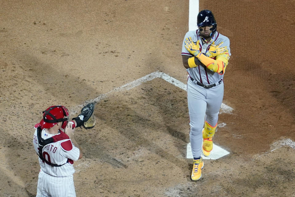 Atlanta Braves' Ronald Acuna Jr., right, reacts after hitting a two-run home run against Philadelphia Phillies pitcher Zack Wheeler during the fifth inning of a baseball game, Tuesday, Sept. 12, 2023, in Philadelphia. (AP Photo/Matt Slocum)