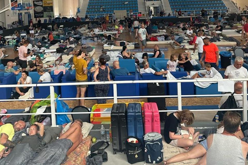 Holidaymakers sleep on floor of basketball stadium in Rhodes (Marc Hall)