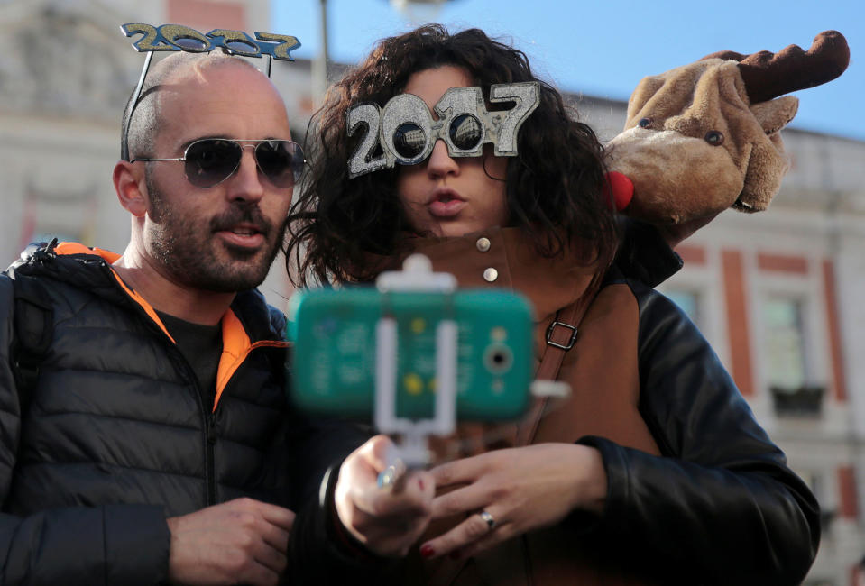 People pose for a selfie ahead of New Year’s Eve in Madrid, Spain