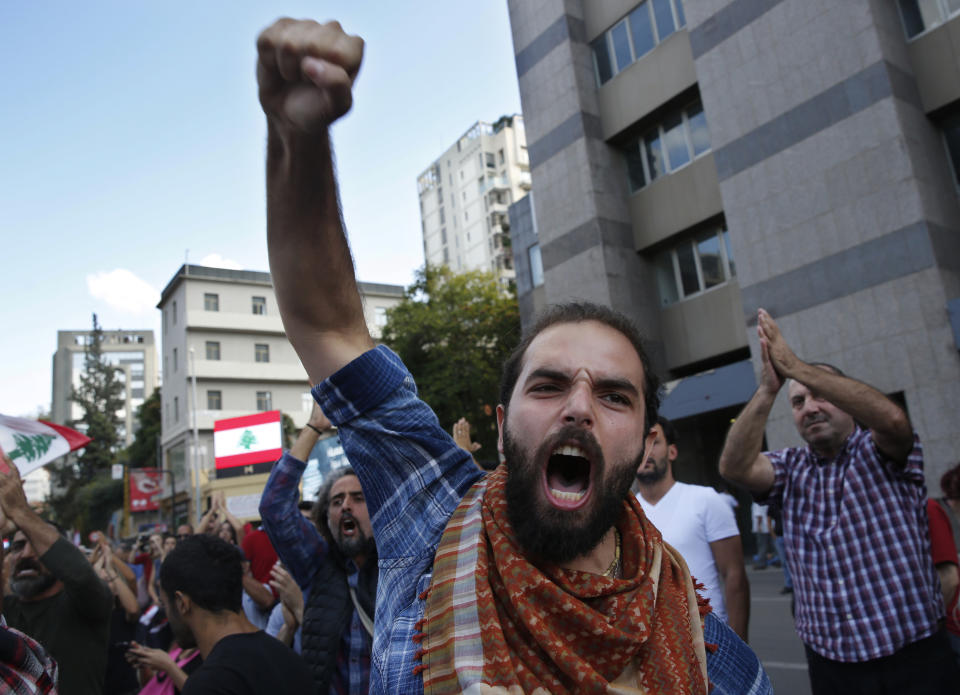 FILE - In this Oct. 29, 2019 file photo, an anti-government protester shots slogans after he was attacked by Hezbollah supporters, in Beirut, Lebanon. Lebanon’s protests have shown unusual overt anger at the country’s powerhouse, Hezbollah. (AP Photo/Hussein Malla, File)