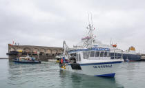 French fishing vessels block the port of St Helier in Jersey, Thursday, May 6, 2021. French fishermen angry over loss of access to waters off their coast have gathered their boats in protest off the English Channel island of Jersey. The head of a grouping of Normandy fishermen said about 50 boats from French ports joined the protest Thursday morning and gathered their fleet off the Jersey port of St. Helier. (Gary Grimshaw/Balliwick Express via AP)