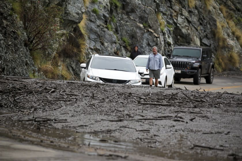 Azusa, CA - January 29: One car stuck and couple of motorists stranded after a mudslide caused by heavy rain on Highway 39 on Friday, Jan. 29, 2021 in Azusa, CA.(Irfan Khan / Los Angeles Times)