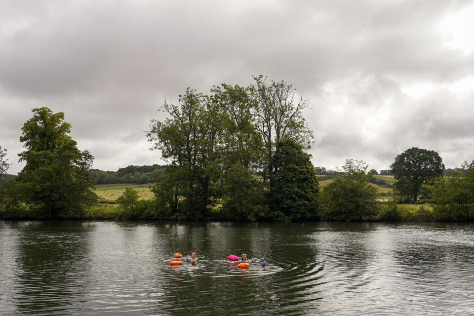 A group of people swim in the river Thames in Henley-on-Thames, England, Friday, June 14, 2024. Britain has become notorious as a place where a casual swim could lead to an extended visit to the toilet, if not the hospital. A torrent of news on dirty water has spilled into next month's election to determine which party controls government for the next four or five years. (AP Photo/Alberto Pezzali)