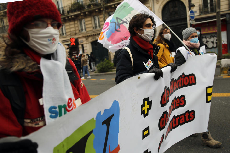 Protestors march during a demonstration in Paris, Tuesday Jan.26, 2021. Schoolteachers and university students marched together in protests or went on strike Tuesday around France to demand more government support amid the pandemic. (AP Photo/Christophe Ena)