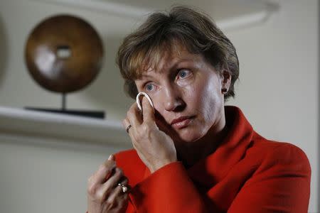 Marina Litvinenko, the wife of former KGB agent Alexander Litvinenko who was murdered in London in 2006, wipes away a tear during an interview with Reuters in London January 21, 2015. REUTERS/Luke MacGregor