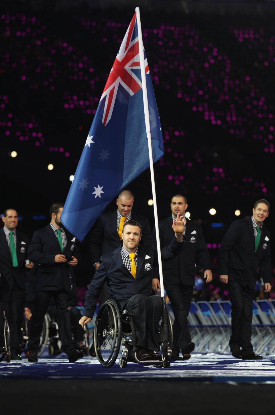 LONDON, ENGLAND - AUGUST 29: Wheelchair rugby player Greg Smith of Australia carries the flag during the Opening Ceremony of the London 2012 Paralympics at the Olympic Stadium on August 29, 2012 in London, England. (Photo by Clive Rose/Getty Images)