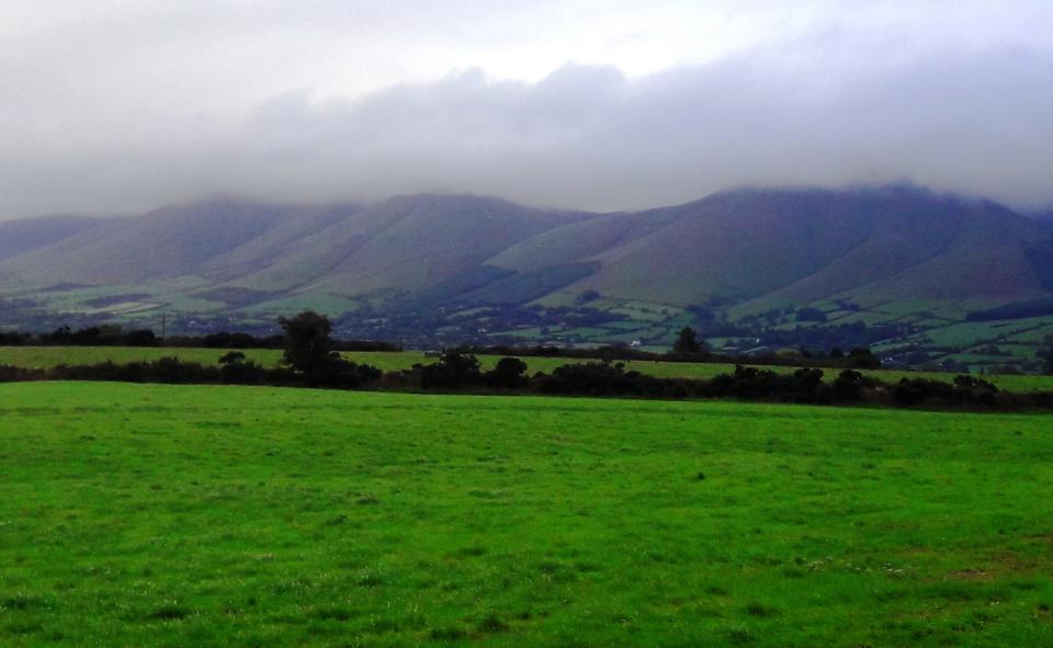 The Galtee Mountains of Ireland lie under a veil of clouds.