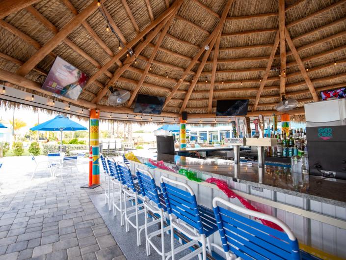 A bar under a wooden and thatched roof.