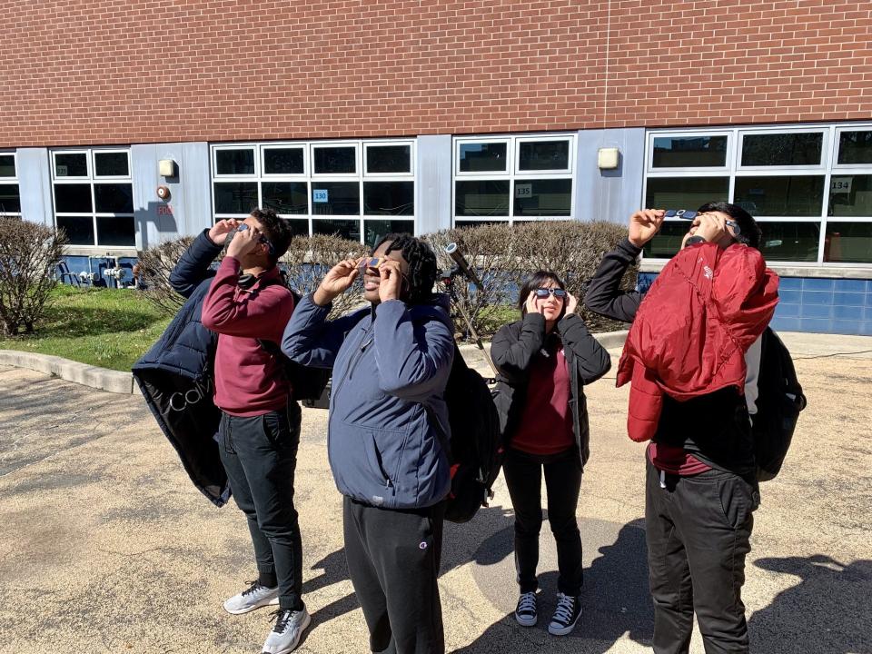 Paterson School District's P-Tech High School students try on solar shades certified for safely viewing the Great Eclipse on April 8.