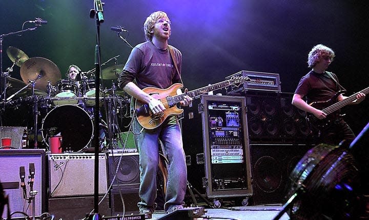 The group Phish, led by Trey Anastasio, center, performs Tuesday, Dec. 31, 2002 at New York's Madison Square Garden.