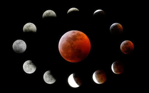 This combination photo shows the totally eclipsed moon, centre, and others at the different stages during a total lunar eclipse, as seen from Los Angeles, Sunday, Jan. 20, 2019