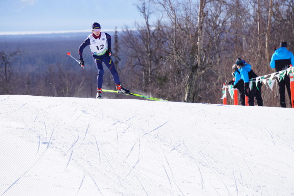 Javva Mathias Lemet Kalstad-Bjorgard of the Scandinavia's Team Sampi crests a hill in the lead of his sprint heat on March 14, 2024 during the Arctic Winter Games cross-country skiing competition at Government Peak Recreation Area. (Photo by Yereth Rosen/Alaska Beacon)